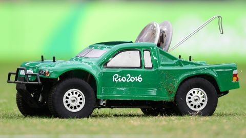 A remote-control car carries the discus in the men's qualifying round.