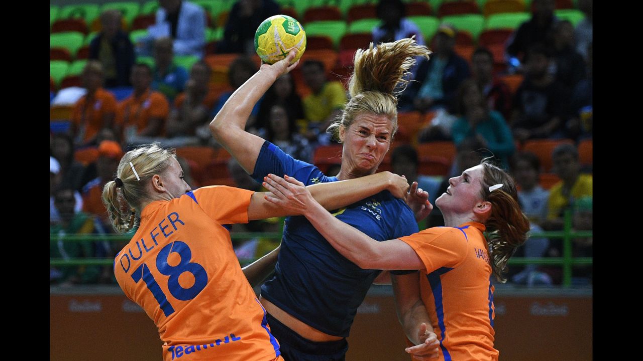 Sweden's Linnea Torstensson, center, competes against the Netherlands' Kelly Dulfer and Laura van der Heijden during a preliminary handball match.