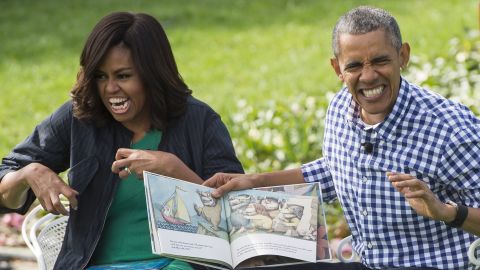 US President Barack Obama and First Lady Michelle Obama read the book, "Where the Wild Things Are," during the annual Easter Egg Roll on the South Lawn of the White House in Washington, DC, March 28, 2016.