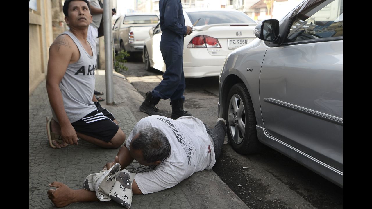 An injured man is seen on the ground after a small bomb exploded in Hua Hin on August 12.
