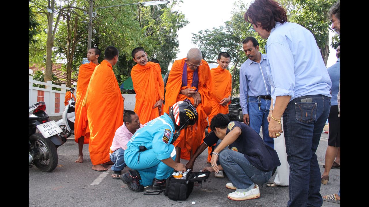 A Buddhist monk is treated for a foot wound at the scene of an explosion in the southern province of Surat Thani on August 12.
