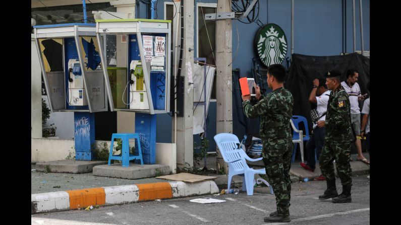 Thai officials document the site of an explosion near a Starbucks coffee shop in Hua Hin on Friday, August 12. The series of attacks comes just days after the country voted on a controversial constitutional amendment, which gives the ruling military more power.