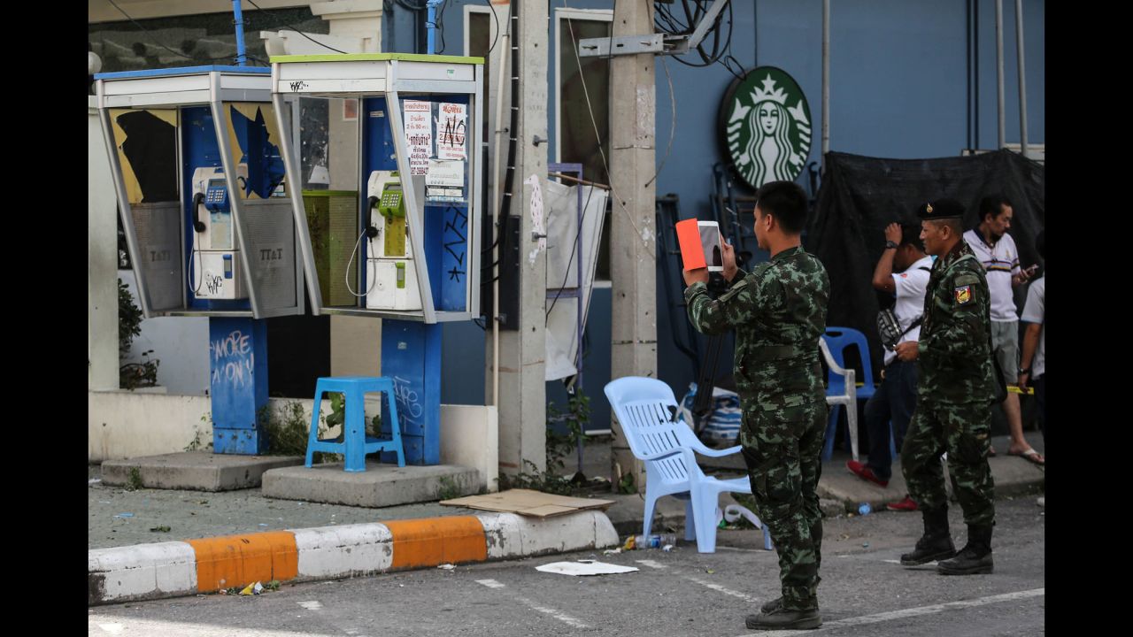 Thai officials document the site of an explosion near a Starbucks coffee shop in Hua Hin on Friday, August 12. The series of attacks comes just days after the country voted on a controversial constitutional amendment, which gives the ruling military more power.