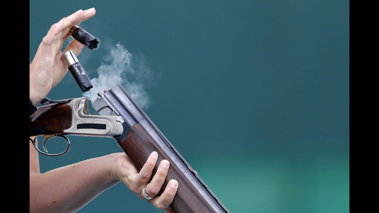 Christine Wenzel of Germany ejects cartridges during skeet qualification.