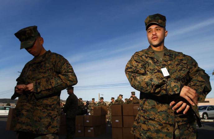 Marines try on the Marine Corps Combat Utility Uniform in 2002. The uniform has a digital-like pattern of squares designed for effective camouflaging, combat utility and durability.