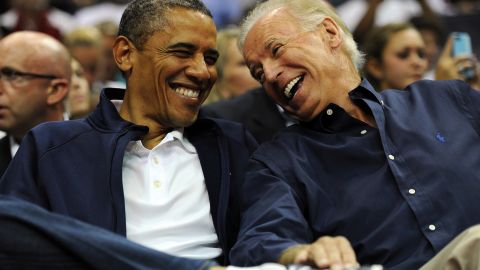 Then-President Barack Obama and Vice President Joe Biden share a laugh during a pre-Olympic exhibition basketball game on July 16, 2012 in Washington, DC.
