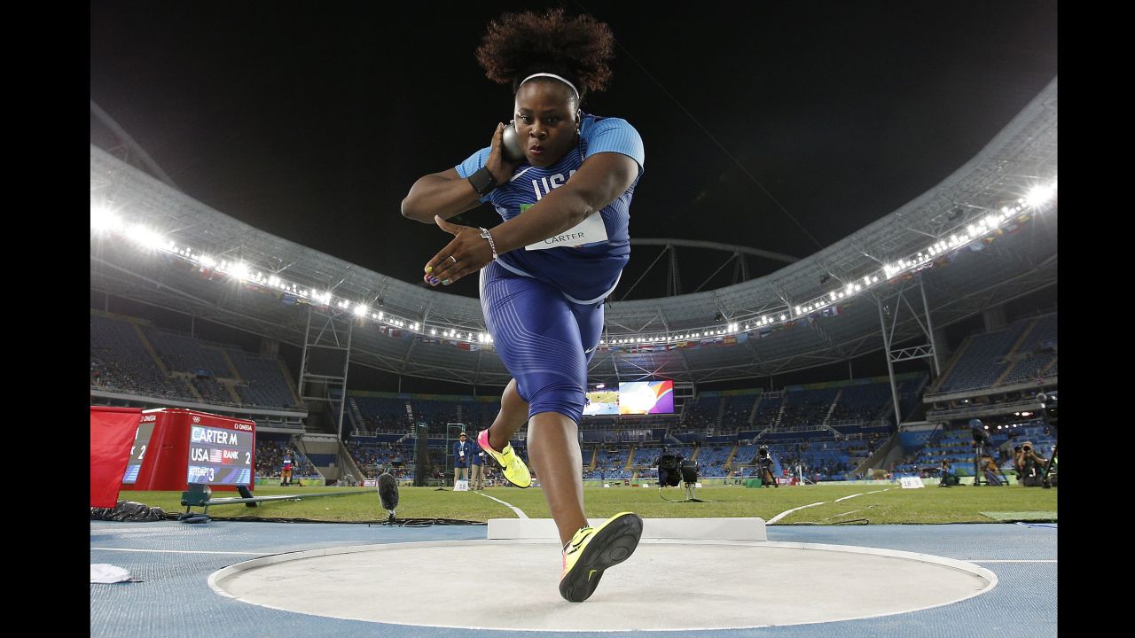 U.S. athlete Michelle Carter competes in the shot put final. She won gold with a throw of 20.63 meters, becoming the first American woman ever to win the event. Carter's father, former NFL player Michael Carter, won Olympic silver in the shot put in 1984.