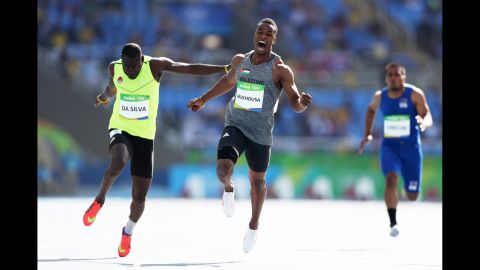 Mohammed Abukhousa of Palestine, center, and Holder da Silva of Guinea-Bissau compete in the men's 100-meter preliminary round. Abukhousa was later carried off the field after an injury.