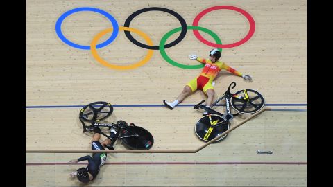 New Zealand's Olivia Podmore, left, and Spain's Tania Calvo Barbero fall during the keirin first round track cycling event.