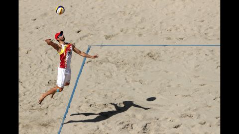 Adrian Gavira Collado of Spain serves the ball during a round of 16 beach volleyball match.