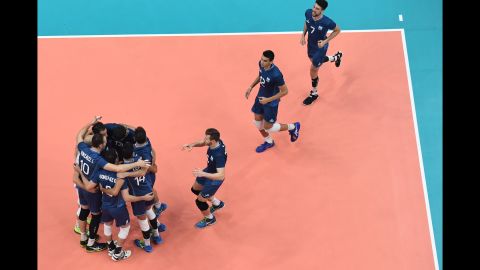 Argentina's players celebrate after winning their qualifying volleyball match against Cuba.