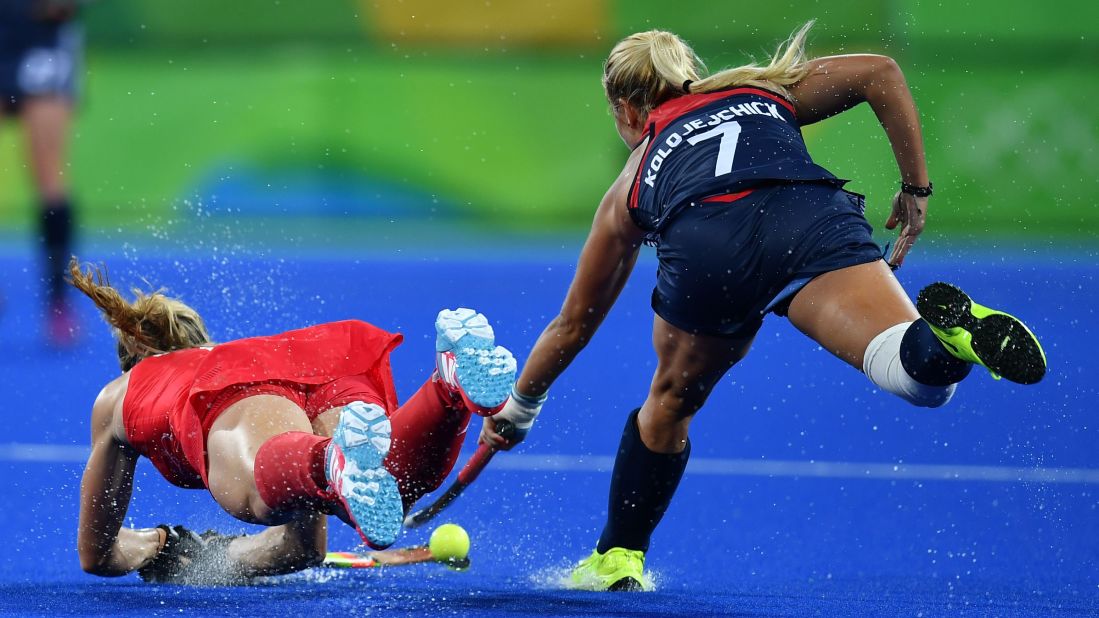 US field hockey player Kelsey Kolojejchick, right, vies for the ball with Great Britain's Crista Cullen.