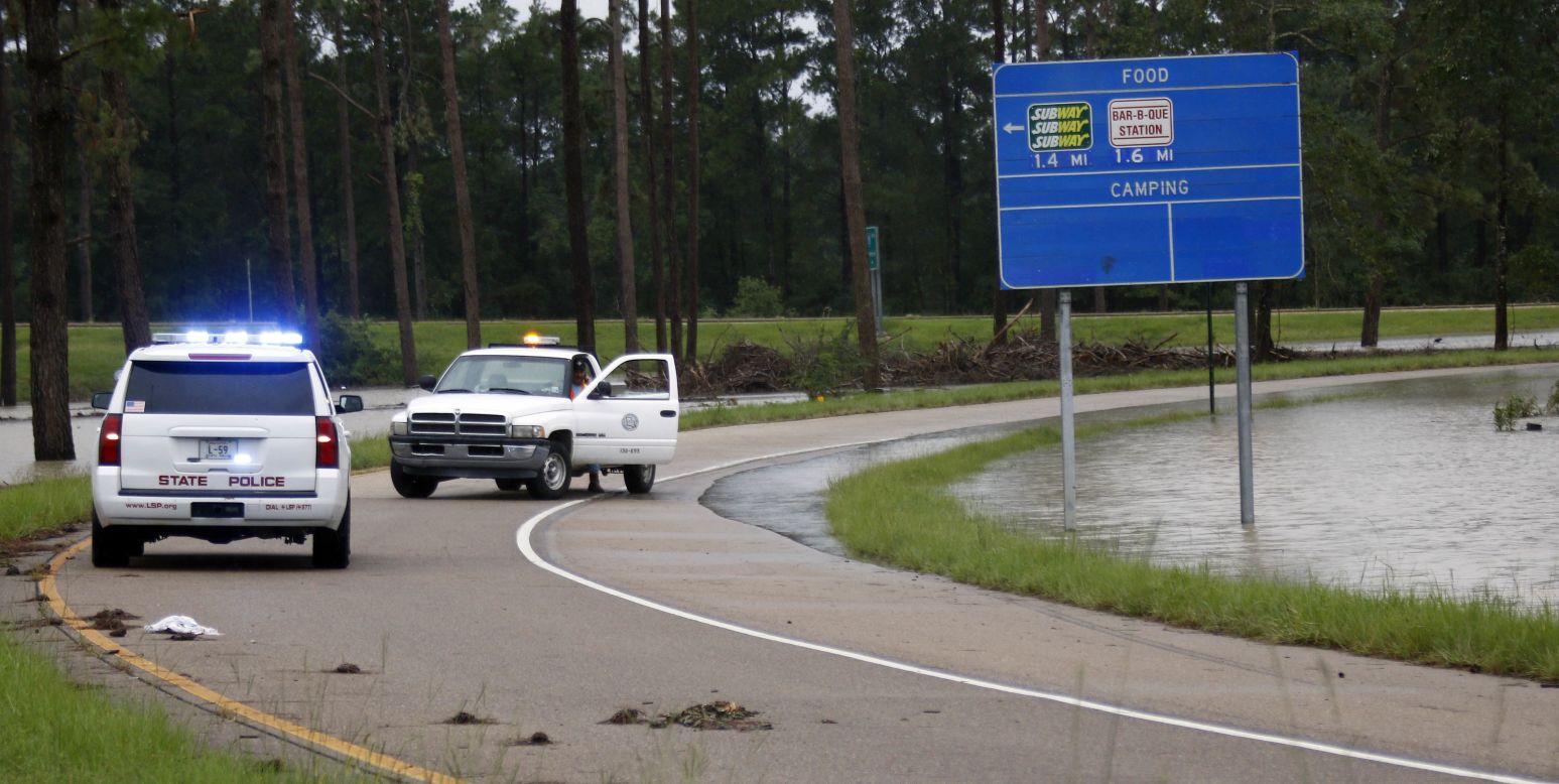 Officials close down an exit off Interstate 55 south in Independence as floodwaters creep closer to the highway on August 13.