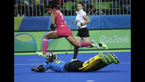 Field hockey player Aki Mitsuhashi of Japan, top, fights for the ball with Australia's goalkeeper Rachael Lynch during their preliminary match.