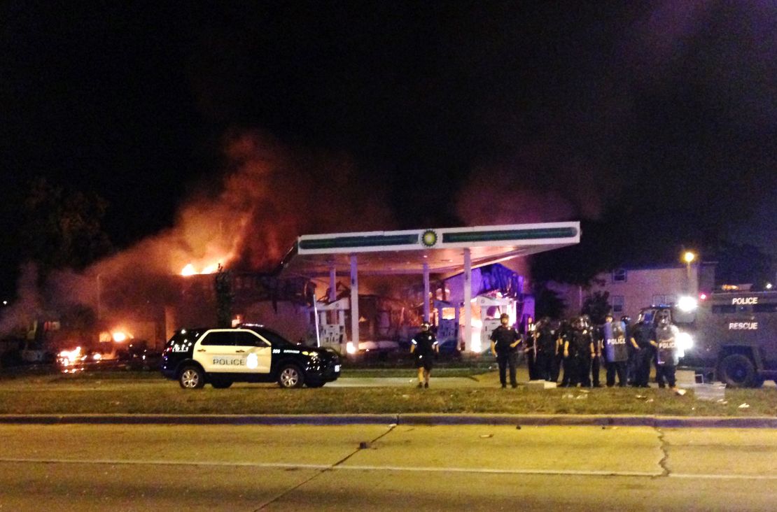 A gas station burns as dozens protest in Milwaukee on Aug. 13.