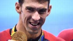 USA's Michael Phelps poses with his gold medal during the podium ceremony of the Men's swimming 4 x 100m Medley Relay Final at the Rio 2016 Olympic Games at the Olympic Aquatics Stadium in Rio de Janeiro on August 13, 2016.  