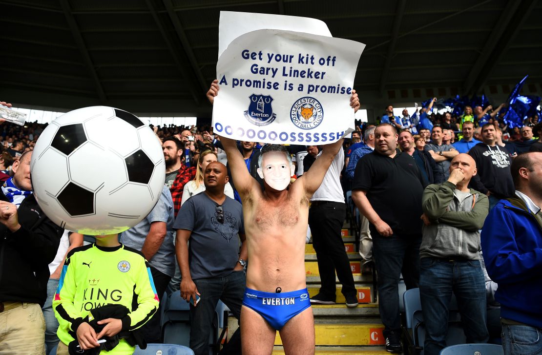 An Everton supporter holds a sign in May urging BBC presenter Gary Lineker to keep his promise.