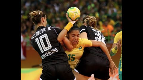 Francielle Rocha of Brazil, center, tries to get past Andela Bulatovic, left, and Katarina Bulatovic of Montenegro during a handball match between their two countries.