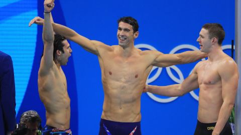 Cody Miller (left), Michael Phelps (center) and Ryan Murphy celebrate winning gold in the medley relay.