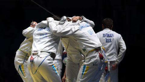 Ukraine's fencing team celebrates after winning the men's team epee quarter-final bout against Russia.
