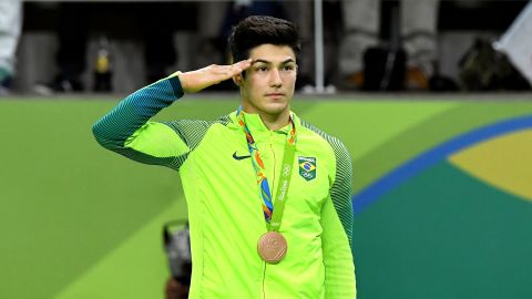 Bronze medalist Arthur Mariano of Brazil salutes during the medal ceremony for Men's Gymnastics Floor Exercise.