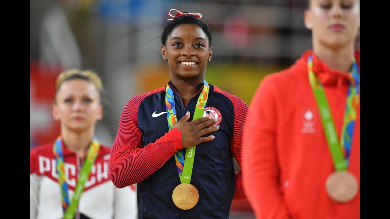 Simone Biles smiles on the podium after <a href="index.php?page=&url=http%3A%2F%2Fcnn.com%2F2016%2F08%2F14%2Fsport%2Fsimone-biles-third-gold-medal-gymnastics-vault%2Findex.html" target="_blank">winning the gold medal in the women's vault event final.</a>