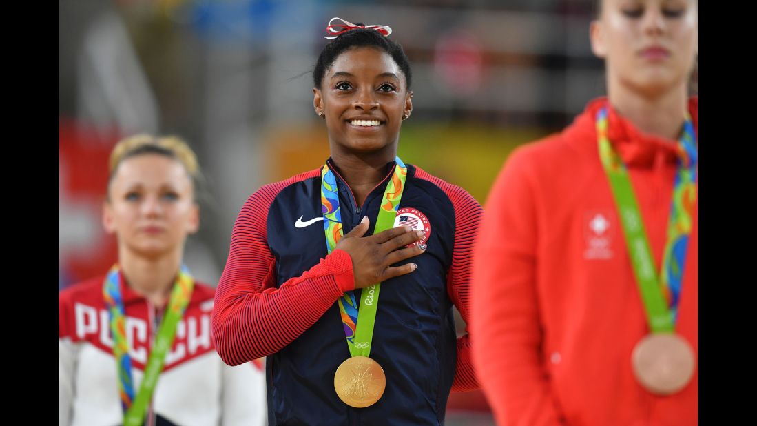 Simone Biles smiles on the podium after <a href="http://cnn.com/2016/08/14/sport/simone-biles-third-gold-medal-gymnastics-vault/index.html" target="_blank">winning the gold medal in the women's vault event final.</a>