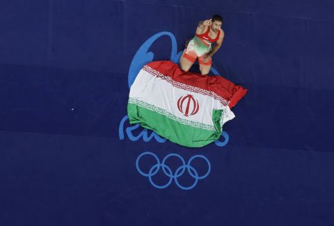 Iran's Saeid Morad Abdvali celebrates after winning the bronze medal in the men's Greco-Roman 75 kg competition.