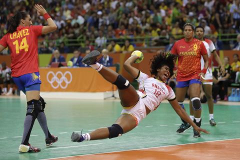 Angola's Albertina Cruz Kassoma, center, is fouled by Spain's Elizabet Chavez during a women's preliminary handball match.