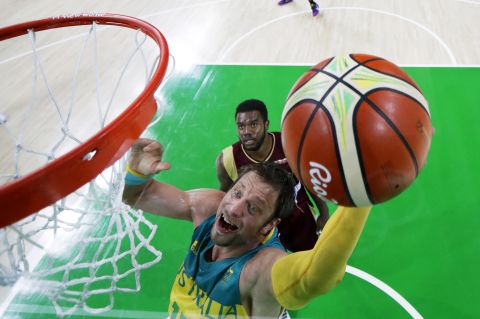 Australia's David Andersen drives to the basket past Venezuela's Nestor Colmenares.