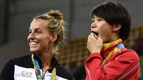 China's gold medalist Shi Tingmao (R) reacts with third-placed Tania Cagnotto of Italy.