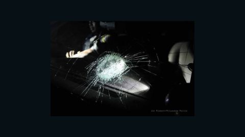 An officer was hospitalized after a rock broke the windshield of a police car.