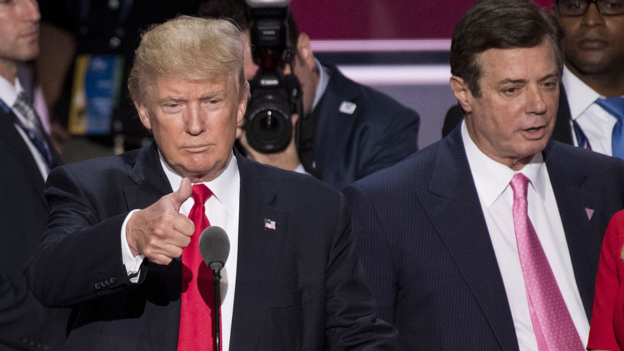 Donald Trump is flanked by then-campaign manager Paul Manafort as he prepares to accept the Republican party's nomination on July 20.