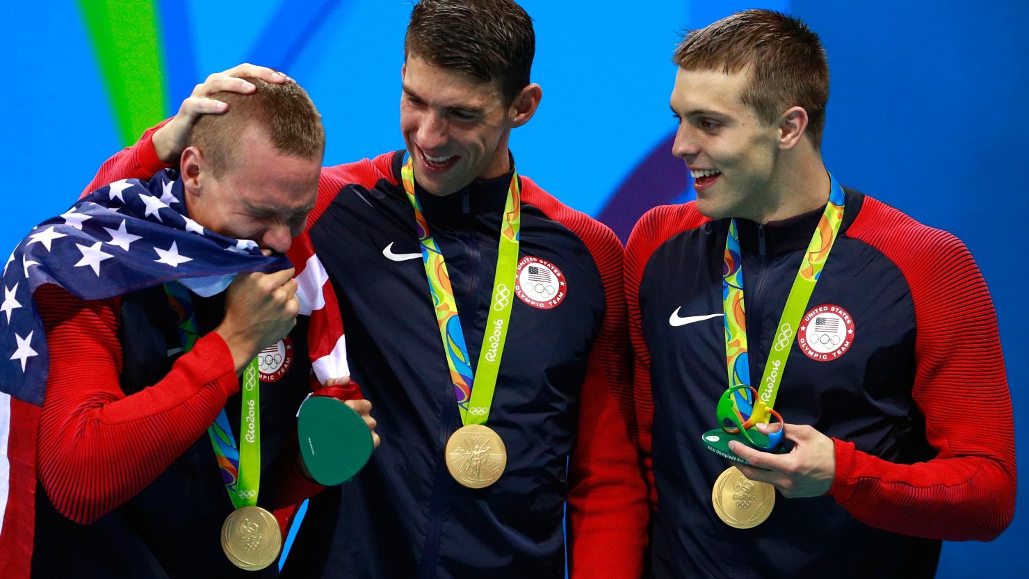 Members of the men's 4 x 100m Freestyle Relay team, including Michael Phelps, with their medal-holders. 