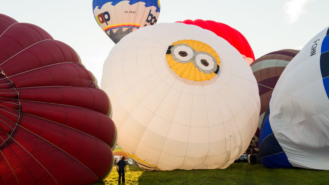 The Despicable Me balloon, a crowd favorite shown at the center here, was the scene of a marriage proposal just before the mass lift Saturday. Chris Tozer, 31, from Bristol, proposed to  Ellen Calvert, also 31 and from the city, moments before the hot air balloon took off. She said yes. 