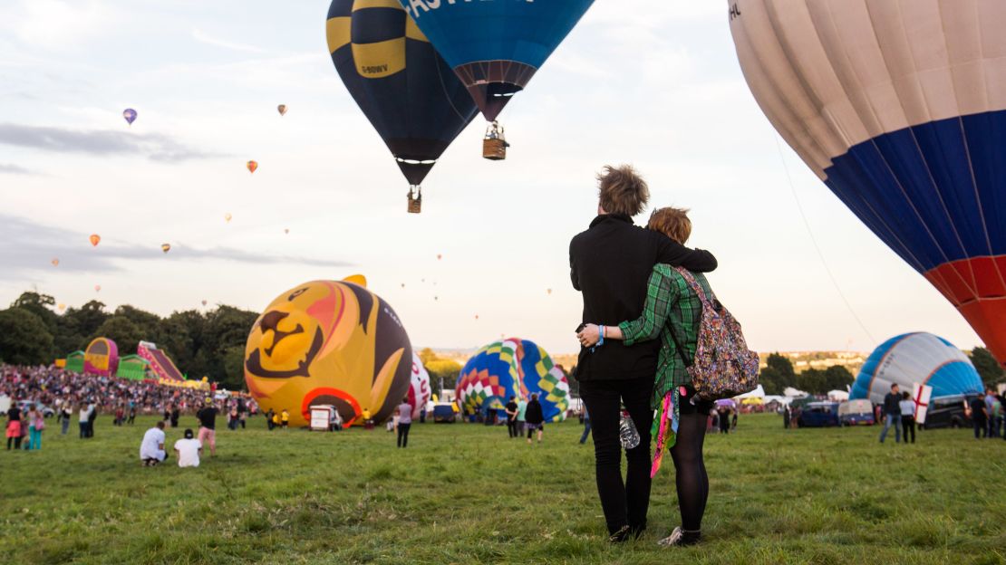 Thomas Lee, left, and Charlie Rotherham, right, share a moment during the mass lift. Lee says that when you're flying in the balloon, "You've got no point of reference up there. Because you're moving with the wind, there's no sense of speed or distance or anything passing, you're just... floating."