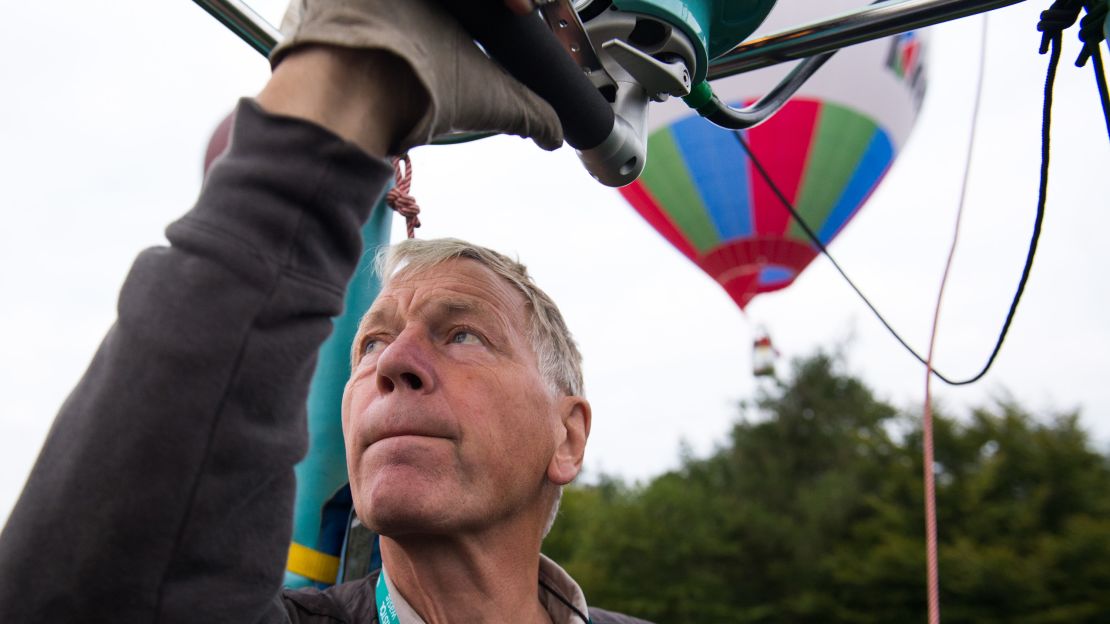 World champion balloon pilot David Bareford watches the positions of other balloons nearby.  Bareford and his co-pilot, John Coleman, explained that winds at different altitudes tend to move in different directions. The skill of a balloon pilot is in understanding this, they said.