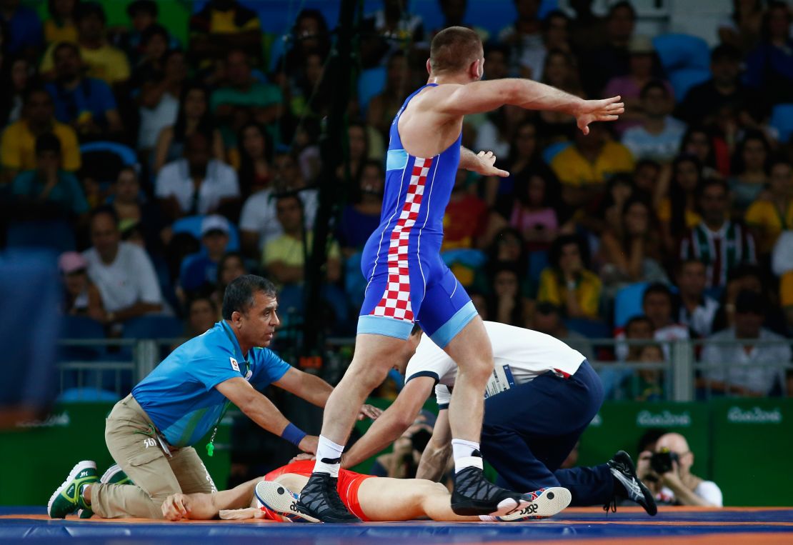 Officials attend Roman Vlasov after he was choked unconscious in his bout against Bozo Starcevic.