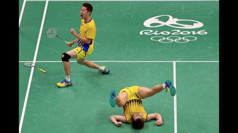 Goh V Shem and Tan Wee Kiong of Malaysia celebrate after winning a quarterfinal badminton match.