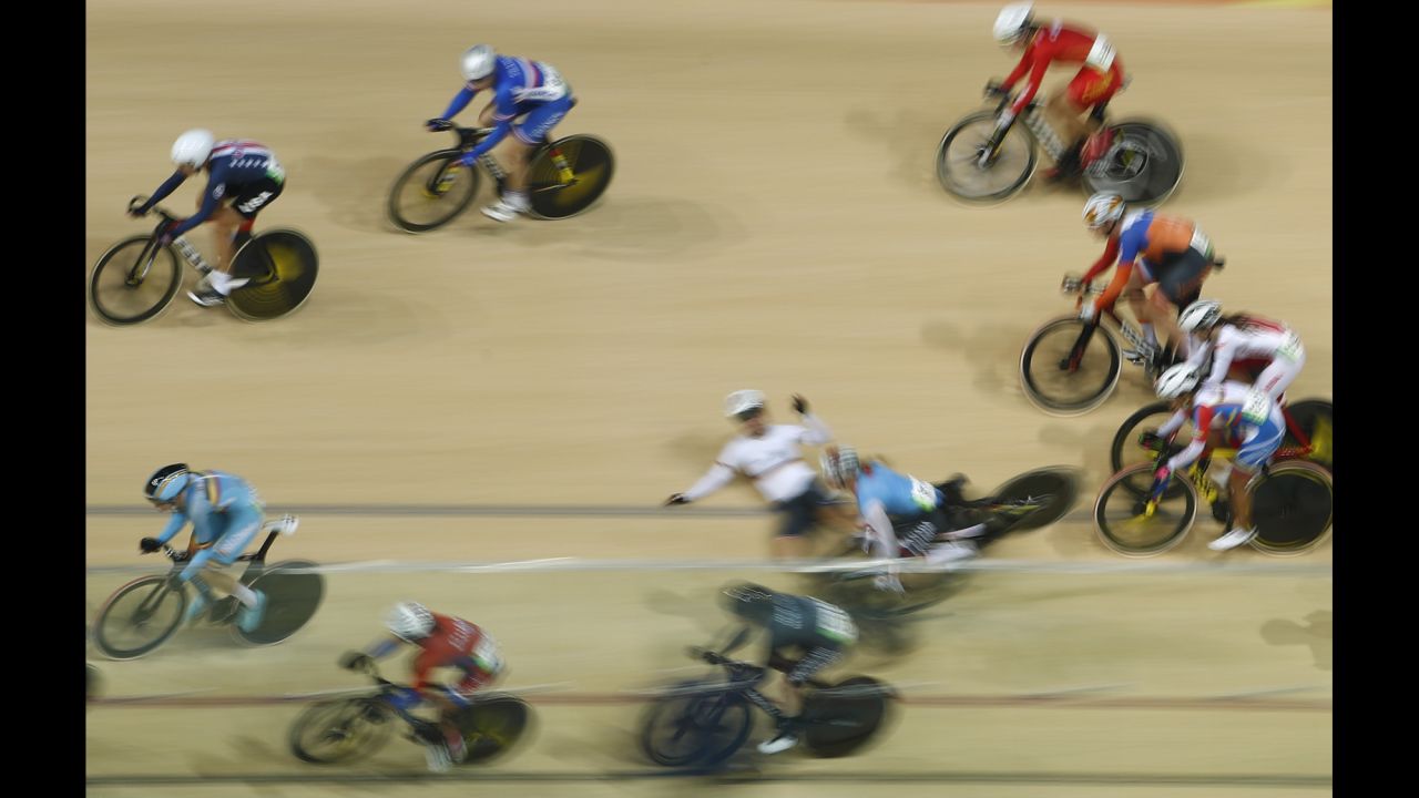 Canada's Allison Beveridge and Germany's Anna Knauer fall during the scratch race portion of the omnium track cycling event.