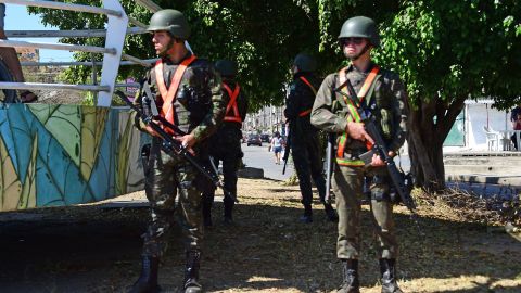 Soldiers patrol near a favela where a National Force officer was killed.
