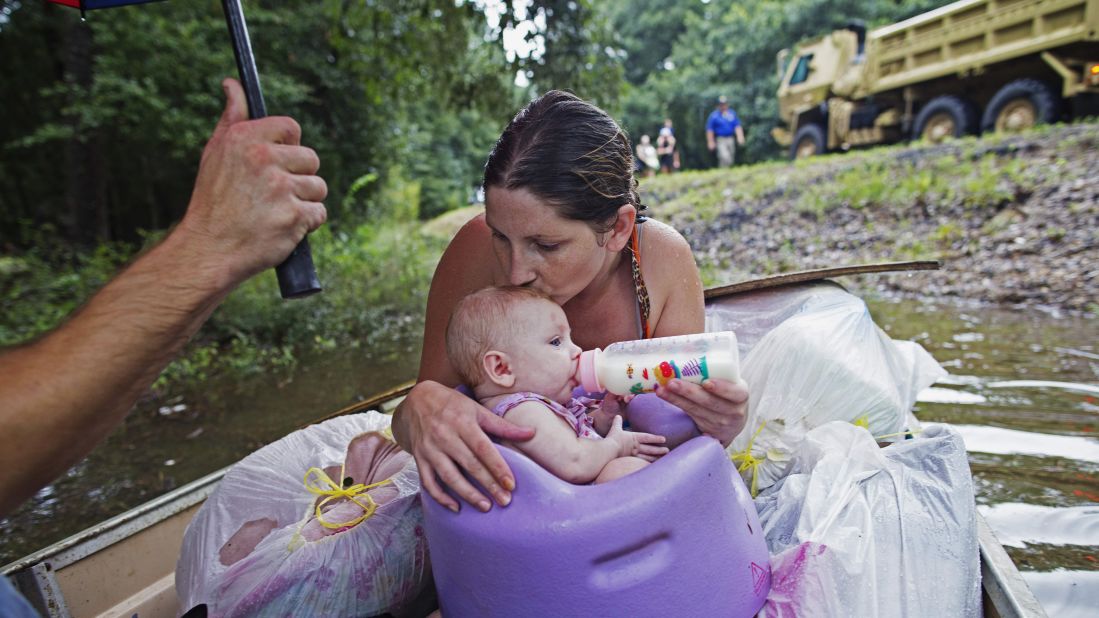 Danielle Blount and her 3-month-old baby, Ember, wait to be rescued by the Louisiana Army National Guard near Walker on Sunday, August 14.