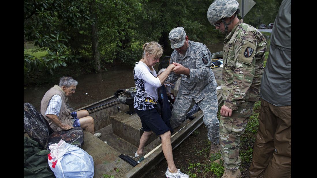 Members of the Louisiana Army National Guard help people near Walker on August 14.