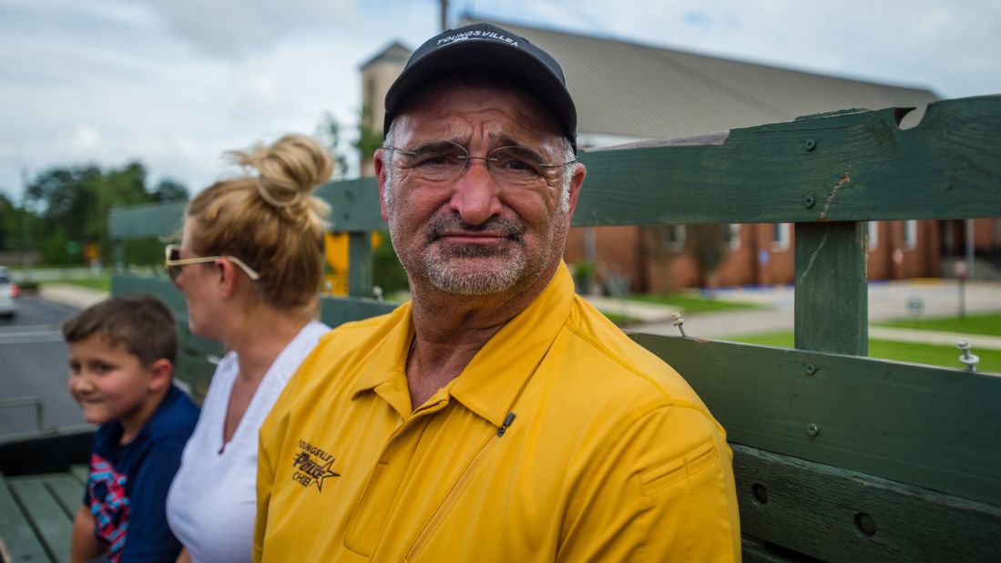 Youngsville police Chief Rickey Boudreaux takes a break from helping flood victims to view the damage to his own home on August 14.