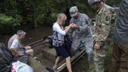 Members of the Louisiana Army National Guard rescue people from rising floodwater near Walker, La., after heavy rains inundated the region, Sunday, Aug. 14, 2016. (AP Photo/Max Becherer)
