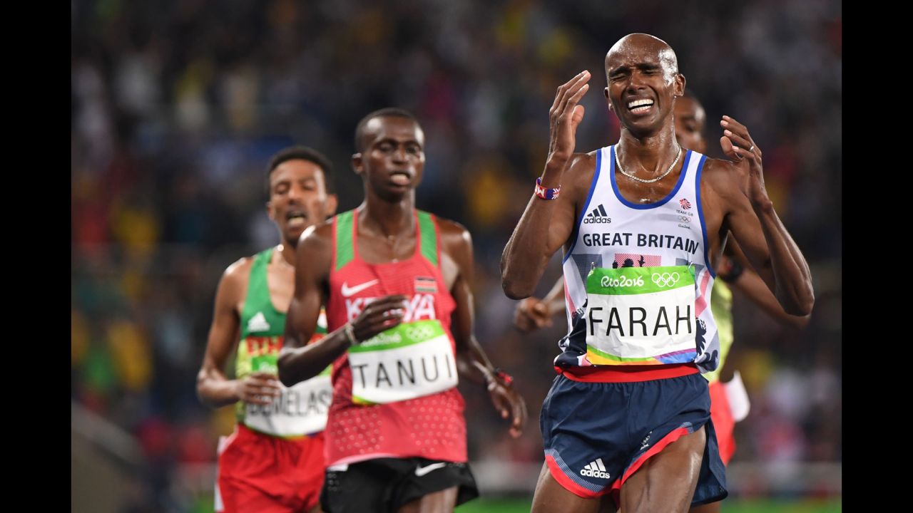 British runner Mo Farah crosses the finish line to successfully defend his 10,000-meter title on Saturday, August 13.