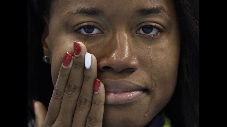 U.S. swimmer Simone Manuel cries during the medal ceremony after <a href="index.php?page=&url=http%3A%2F%2Fwww.cnn.com%2F2016%2F08%2F14%2Fsport%2Frio-olympics-manuel-usa-1000-golds%2F" target="_blank">winning the 100-meter freestyle</a> on Friday, August 12. Manuel is the first African-American woman to win an individual swimming event in the Olympics.