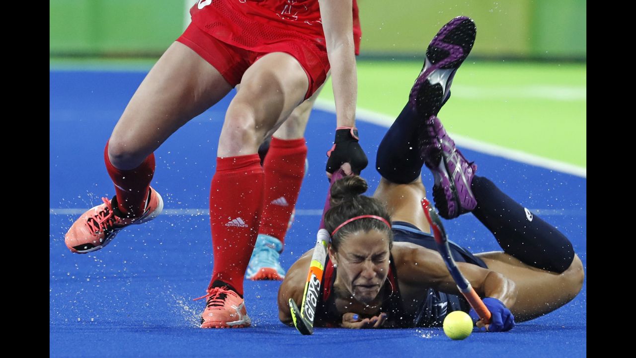 U.S. field hockey player Melissa Gonzalez falls to the turf during a match against Great Britain on Saturday, August 13.