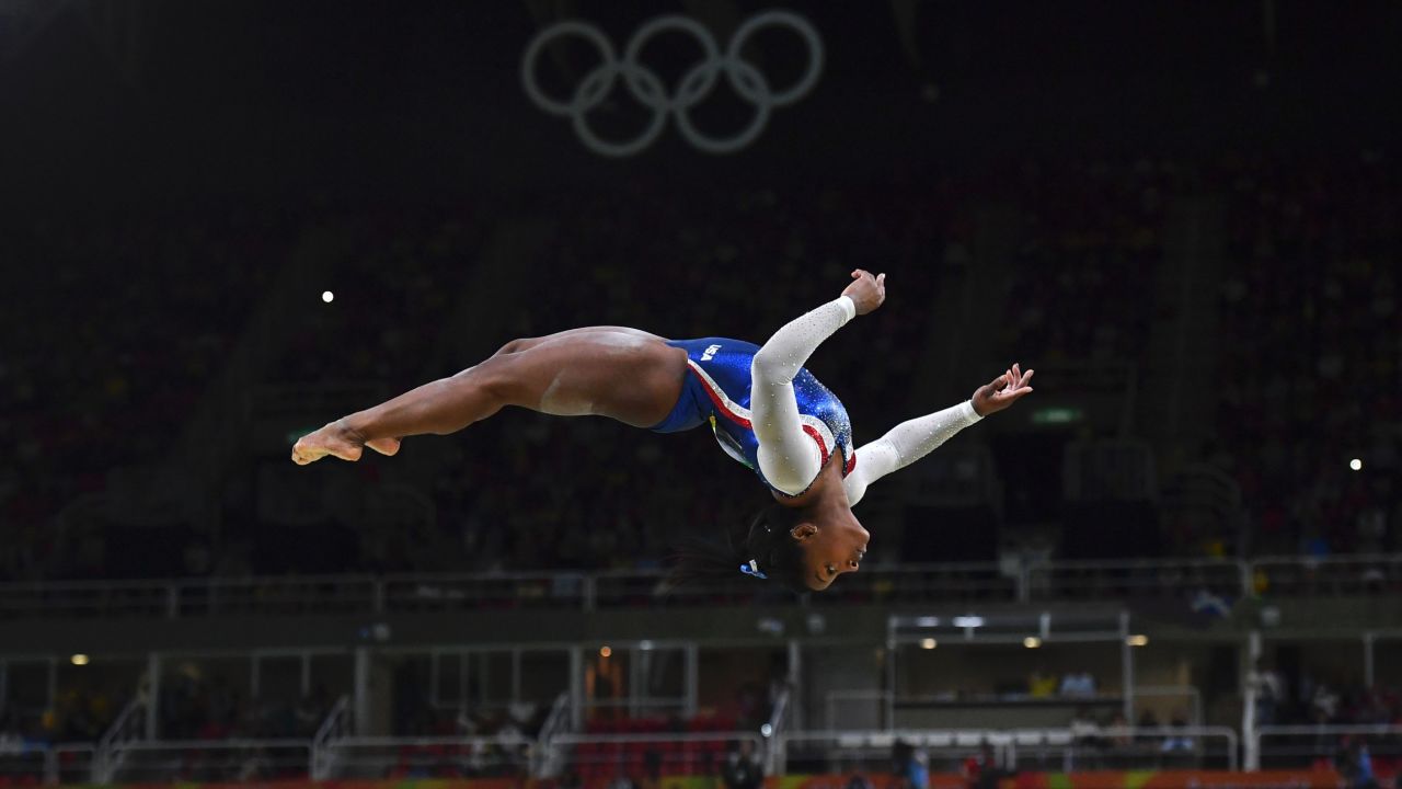 TOPSHOT - US gymnast Simone Biles competes in the beam event of the women's individual all-around final of the Artistic Gymnastics at the Olympic Arena during the Rio 2016 Olympic Games in Rio de Janeiro on August 11, 2016. / AFP / Ben STANSALL        (Photo credit should read BEN STANSALL/AFP/Getty Images)