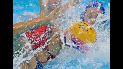 Hungarian goalkeeper Orsolya Kaso, left, competes against Australia in a water polo quarterfinal. Hungary won 13-11.
